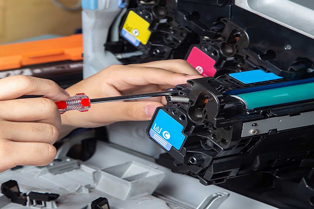 Business man or technician is checking and changing the printer